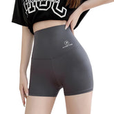 Person wearing gray high-waisted shorts with a brand logo on a light background